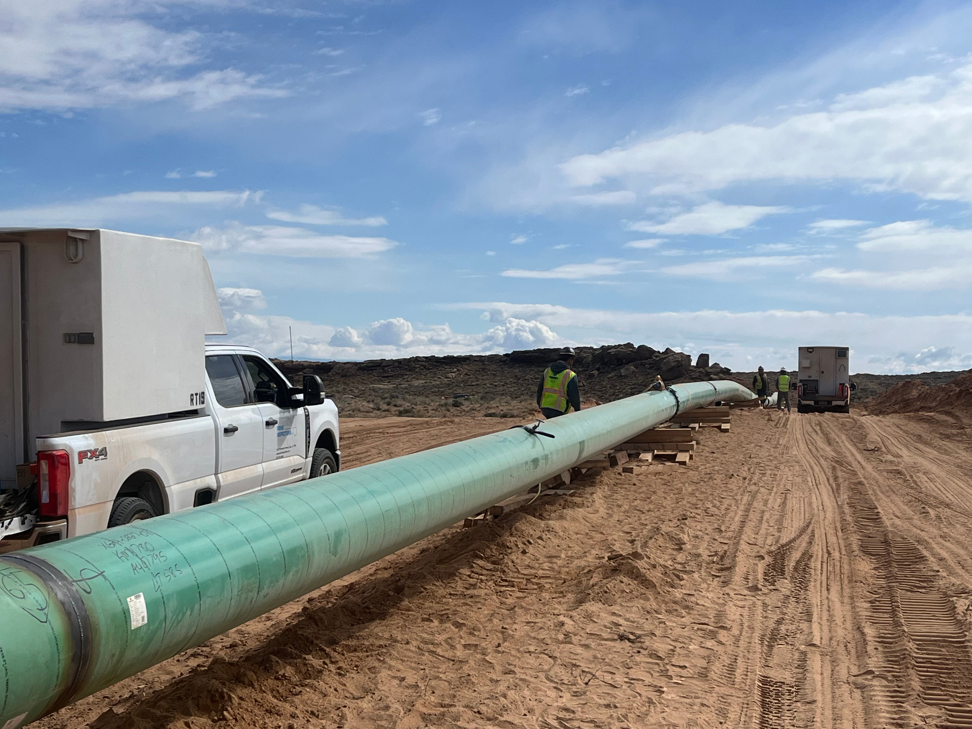 NDT technician performing radiographic inspection on a pipeline girth weld in the field