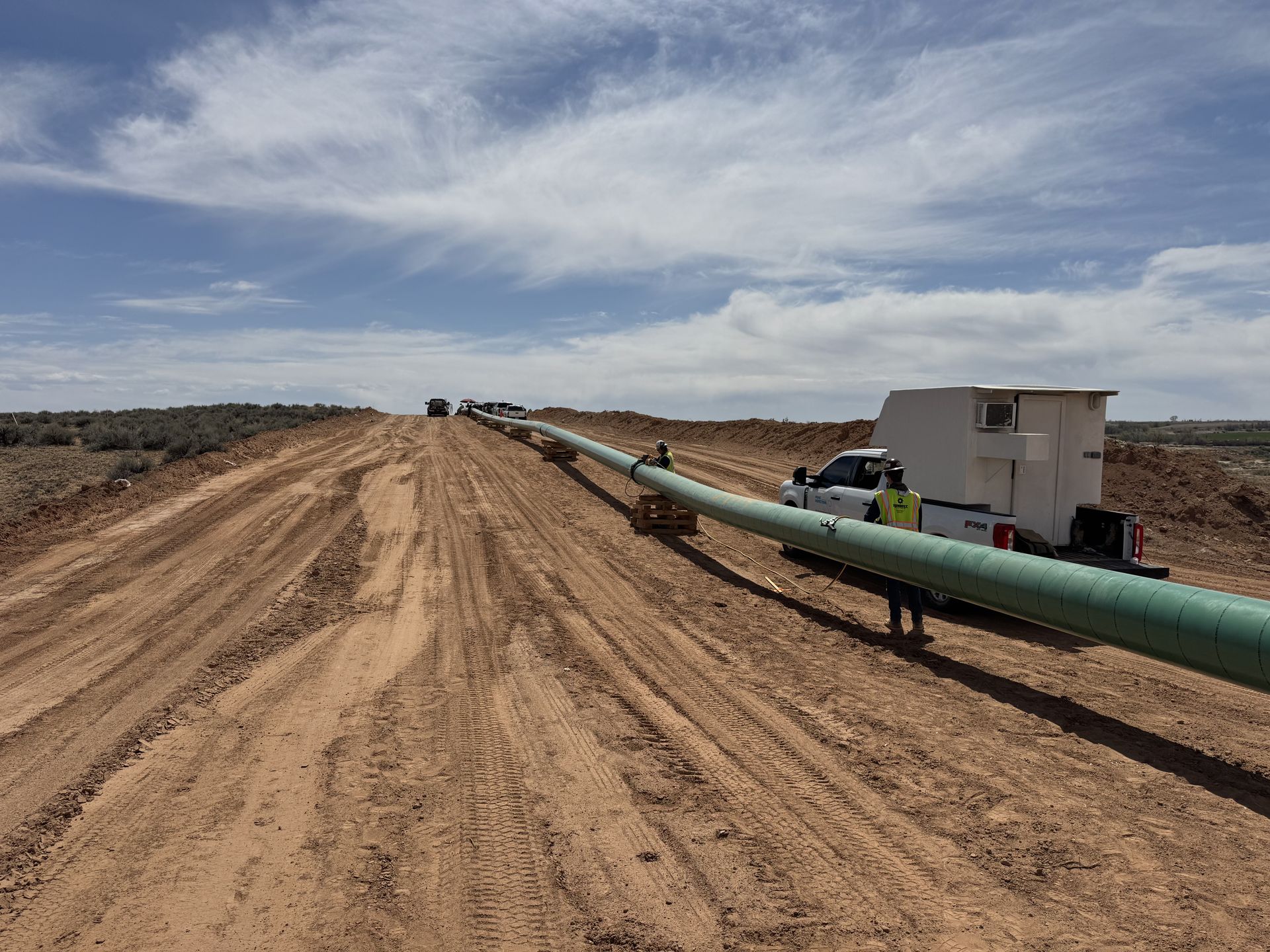 Prime Inspections radiography darkroom truck beside a pipeline string on the right-of-way