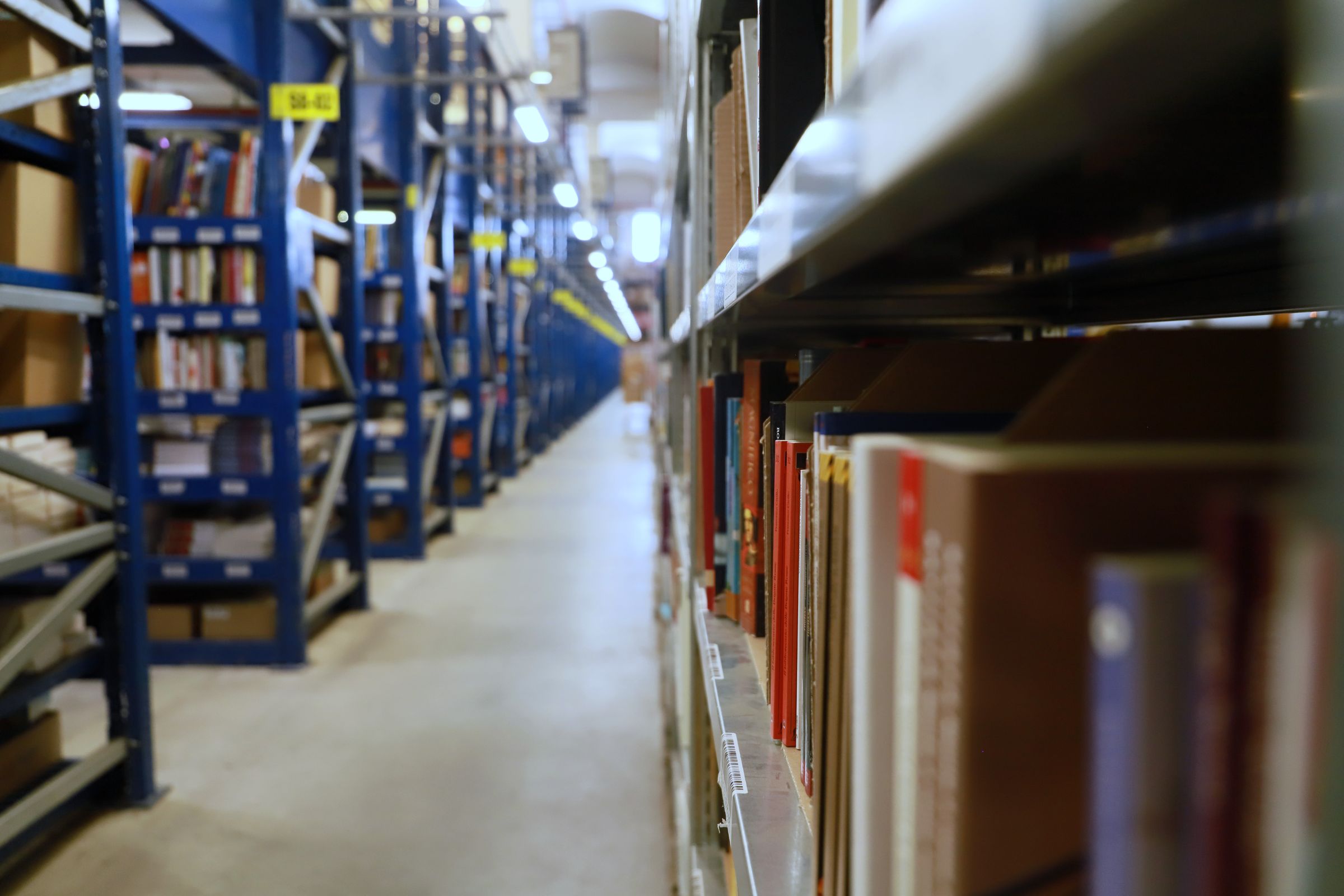 Aisle of industrial archive shelving holding stored records