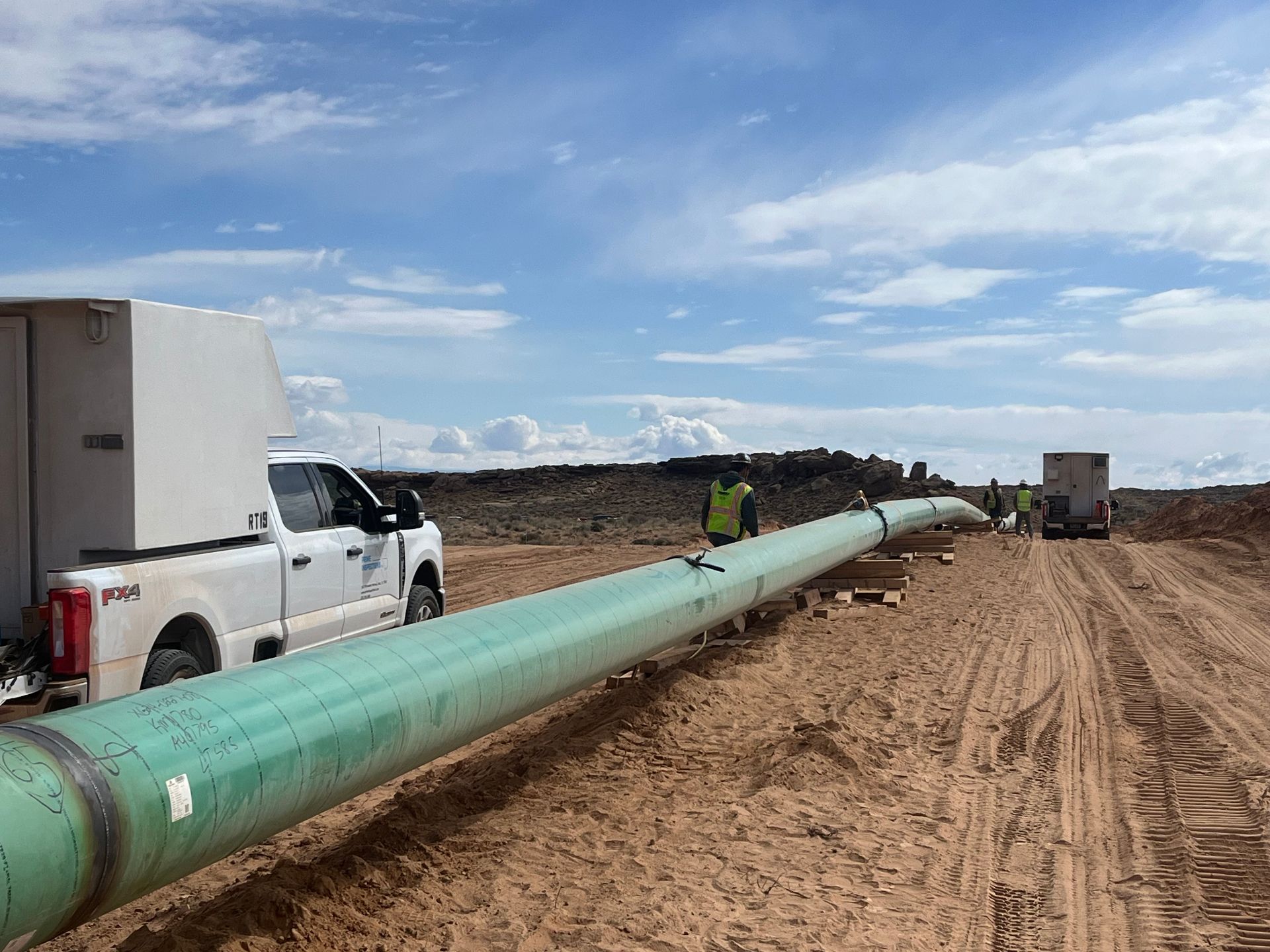 NDT technician performing radiographic inspection on a pipeline girth weld in the field