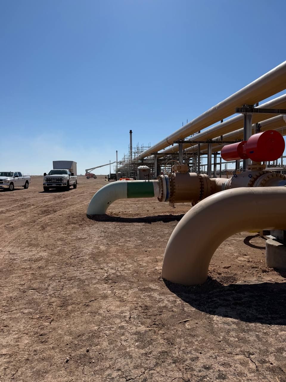 Above-ground process piping, valves and pipe supports at an industrial facility under construction